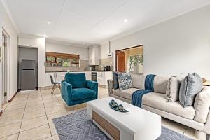 a living room with a couch and a table at Shai in Johannesburg