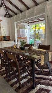 a wooden table and chairs in a living room at Hibiscus Paradise in Vieux-Habitants +72 photos