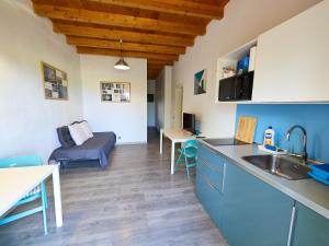 a kitchen and living room with a sink and a couch at Los Lagos in El Roque