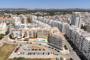 an aerial view of a city with tall buildings at Golfinho - Sea view with pool by HD in Quarteira