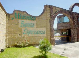 a brick building with an archway in front at Casa del Sol in Toluca