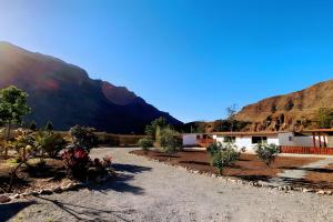 ein Haus mit einem Berg im Hintergrund in der Unterkunft Finca House By Fataga Maspalomas in Artedara