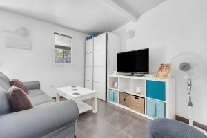 a living room with a couch and a tv at Finca Apartment Near Maspalomas in Artedara