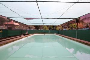 an empty swimming pool with a roof at Finca Apartment Near Maspalomas in Artedara