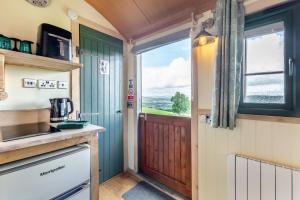 バセンスウェイトにある1 Bed in Keswick oc-f33118の窓付きのキッチンへとつながるドア付きのキッチン +3枚の写真