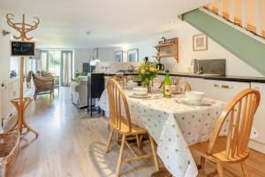 a kitchen and dining room with a table and chairs at 2 Bed in The Hendre oc-h33314 in New Castle +22 photos