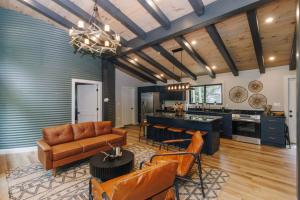 a living room with a couch and a table at NEW Unique Stay w King Beds and Private Hot Tub in Rogers