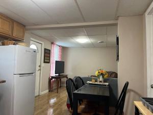 a kitchen and dining room with a table and a refrigerator at Cozy Efficiency Room WalktoUHS, near BU Guthrie in Johnson City