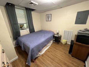 a bedroom with a bed with a purple blanket at Cozy Efficiency Room WalktoUHS, near BU Guthrie in Johnson City