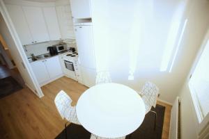 a kitchen with a table and chairs in a room at Convenient Apartment for 4 in Karvsor