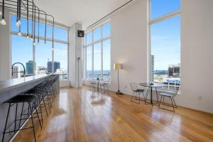 an empty room with a table and chairs and large windows at Luxury Loft 270 views Rooftop Pool Parking in Miami