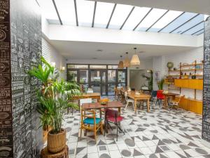 a dining room with tables and chairs and plants at greet Marseille Centre Saint Charles in Marseille