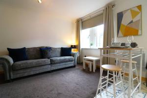 a living room with a couch and a table at Cosy 1 bed flat in central Ayr in Ayr
