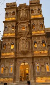 a tall building with a tower with lights on it at Garh Adhiraj A Luxurious Boutique Haveli in Jaisalmer