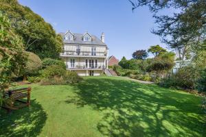 a large house with a large yard with a bench at 3 Bed in Fowey oc-o33078 in Fowey