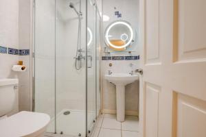 a bathroom with a shower and a sink and a toilet at 3 Bed in Fowey oc-o33078 in Fowey +13 photos
