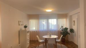 a dining room with a table and chairs and a window at Lea in Križevci