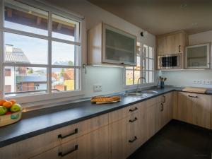 a kitchen with a counter with a sink and a window at Chalet Jornata - OVO Network in Morillon +20 photos