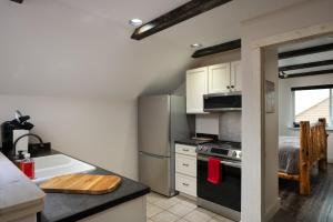 a kitchen with a refrigerator and a stove top oven at Cabin on Horse, Donkey and Cow Farm in Bozeman