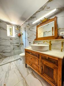 a bathroom with a sink and a mirror at MARY'S HOUSE - Urban Promenade Vibes in Tripolis