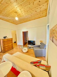 a living room with a bed and a couch at MARY'S HOUSE - Urban Promenade Vibes in Tripolis