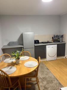 a kitchen with a table and chairs and a kitchen with a refrigerator at Flat 1. Cleethorpes apts in Cleethorpes