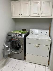 a washing machine and a washer in a kitchen at Homestayyy in Dallas