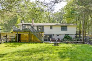 a house with a large yard with a deck at Walk to Mohican Lake Catskills Getaway with Dock! in Glen Spey