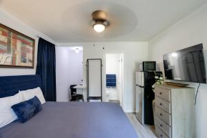 a bedroom with a bed and a refrigerator and a table at Less Than 1 Mi to Dtwn Updated Studio in North Greenwood! in Greenwood