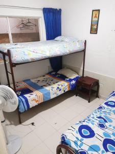 a bedroom with two bunk beds and a window at Casa Acaritama 3 in Melgar