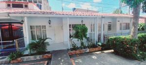 a white house with plants in front of it at Casa Acaritama 3 in Melgar