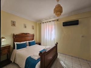 a bedroom with a large bed with blue pillows at Riad Latifa in Marrakech +13 photos
