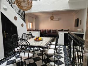 a dining table and chairs in a living room at Riad Latifa in Marrakech