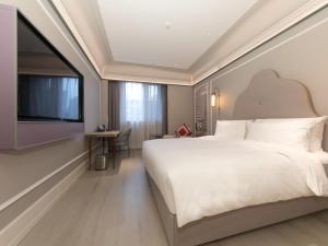 Ένα ή περισσότερα κρεβάτια σε δωμάτιο στο Mercure Xi'an Dayan Pagoda