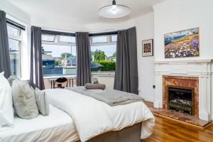 a bedroom with a bed and a fireplace at Luxury 5BD, Gym, Parking, Bus to Airport, Sleeps10 in Edinburgh