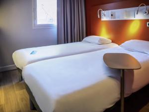 Кровать или кровати в номере ibis budget Reims Parc Des Expositions
