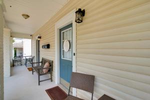 a front porch with a blue door and chairs at Walk to WKU, Bars and Dining! Updated Duplex Home in Bowling Green