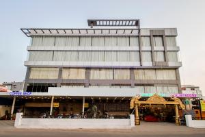 a tall building with a store in front of it at Capital O Wild Wings Hotel Near Omni Hospital Lane Nagole main road in Hyderabad