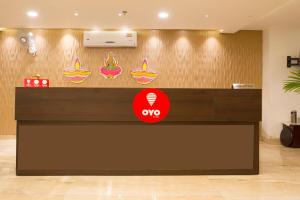 an office reception counter with aoops sign on the wall at Capital O Wild Wings Hotel Near Omni Hospital Lane Nagole main road in Hyderabad