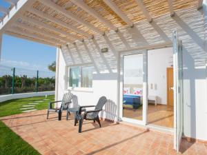 a patio with two chairs and a table at Tavira Monte in Tavira