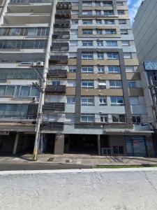a tall building with a street light in front of it at Apartamento Novo e com garagem em frente ao parque da Redenção em Porto Alegre in Porto Alegre +7 photos