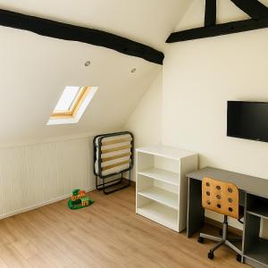 a attic room with a desk and a chair at Villa Petit Charles - CDG Paris airport - Parc Asterix - Extra Shuttle in Le Mesnil-Amelot +3 photos