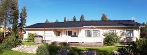 a white house with a black roof at House at the Arctic Circle- next to Santa Claus in Rovaniemi