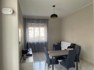 a dining room with a table and chairs and a bed at Daniela; vacanza e/o lavoro in Nichelino +18 photos