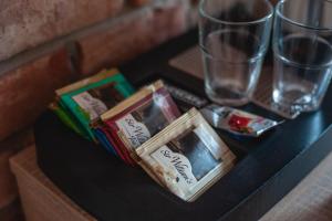 a black table with pamphlets and glasses on it at ApartHOTEL Gostyń in Gostyń