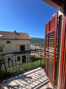 einen Balkon mit einem Eisentor und einem Gebäude in der Unterkunft Villa Maria in Ðenovići