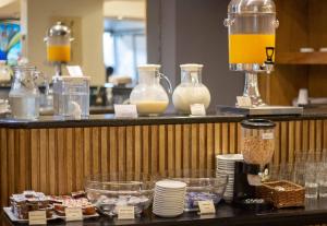 a counter with some food and jars of milk at Hotel Cristoforo Colombo in Buenos Aires