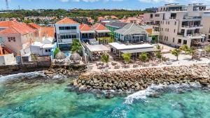 an aerial view of a resort with the ocean at BijBlauw in Willemstad