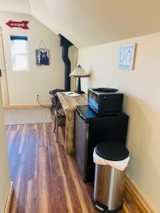 a room with a table with a microwave on top of it at 2 Bedroom Loft on Horse, Goat, Donkey and Cow Farm in Bozeman