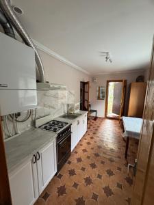 a kitchen with white cabinets and a stove top oven at Квартира подобово in Vinnytsya